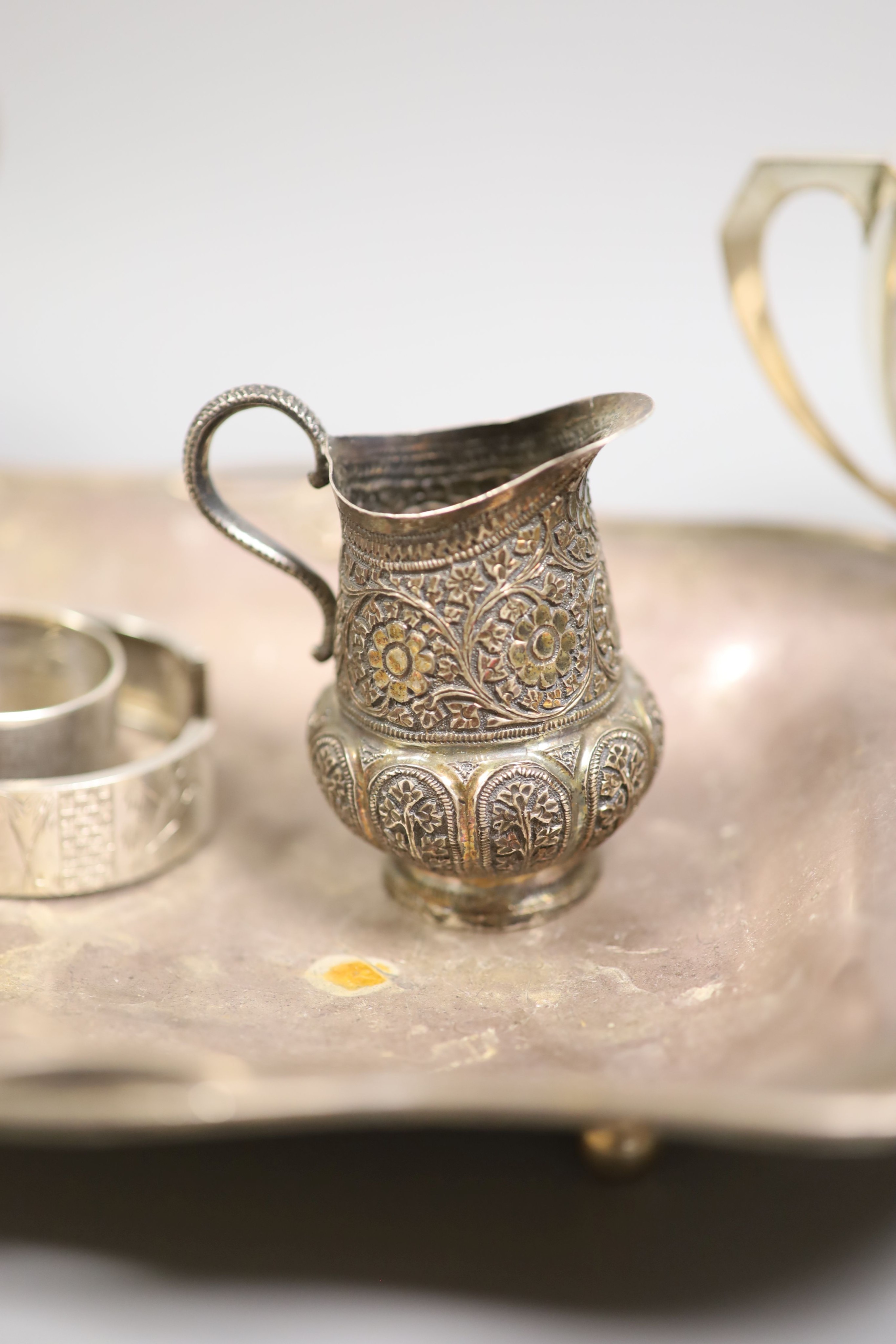 A silver dish, marks rubbed, a silver cream jug, similar 800 jug and five other items, weighable silver 28oz.